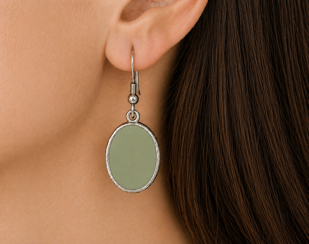 A model wearing some sage green oval dangle drop earrings