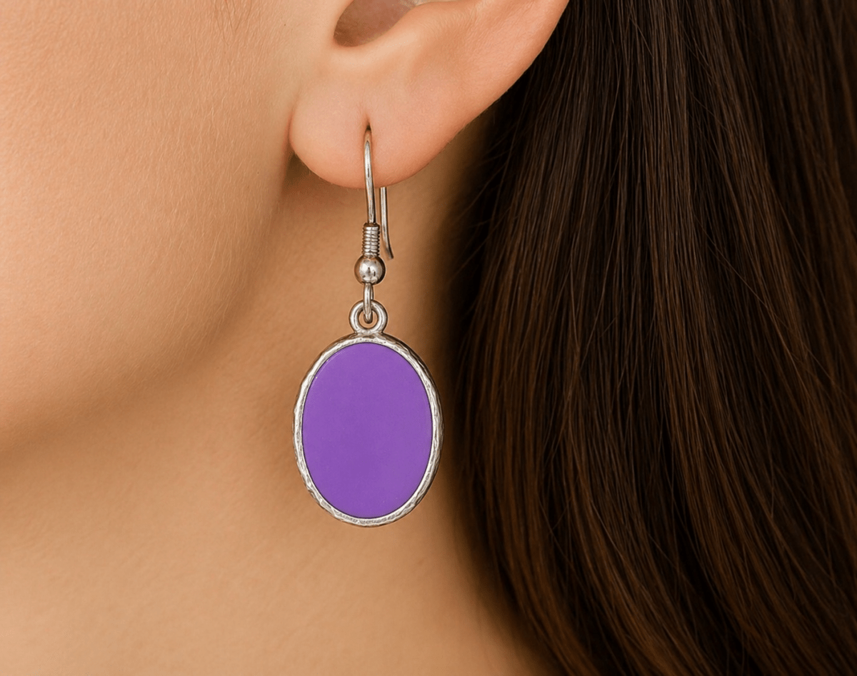 A model wearing some violet oval dangle drop earrings