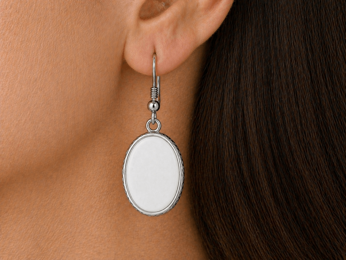 A model wearing some white oval dangle drop earrings