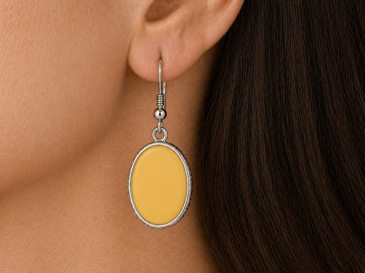 A model wearing some yellow oval dangle drop earrings