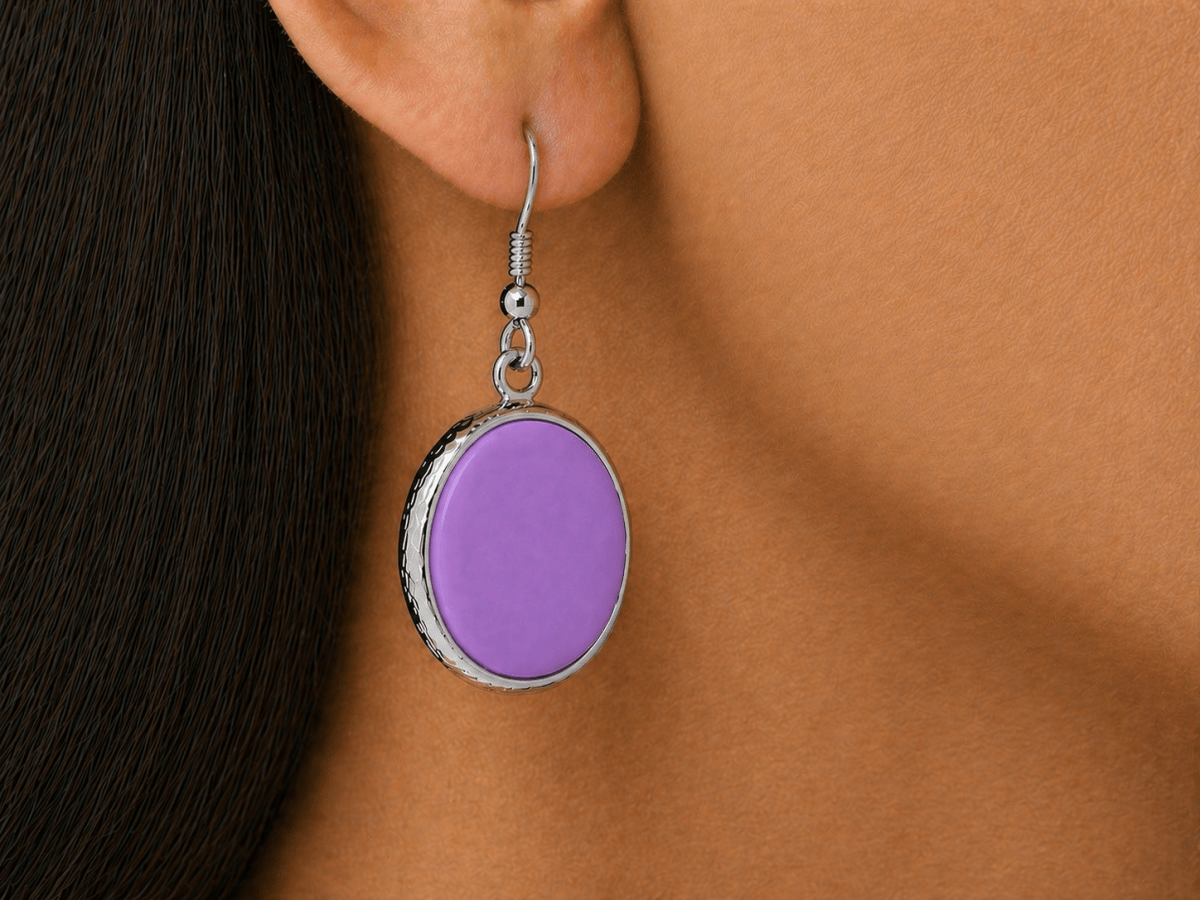 A model wearing some round violet dangle drop earrings