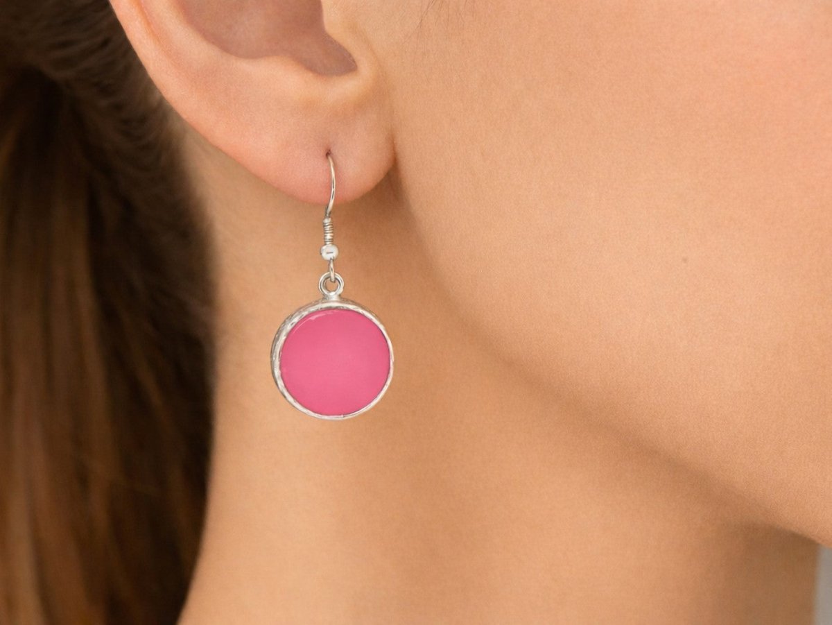Pretty pink circular round dangle drop earrings! Being worn by a model
