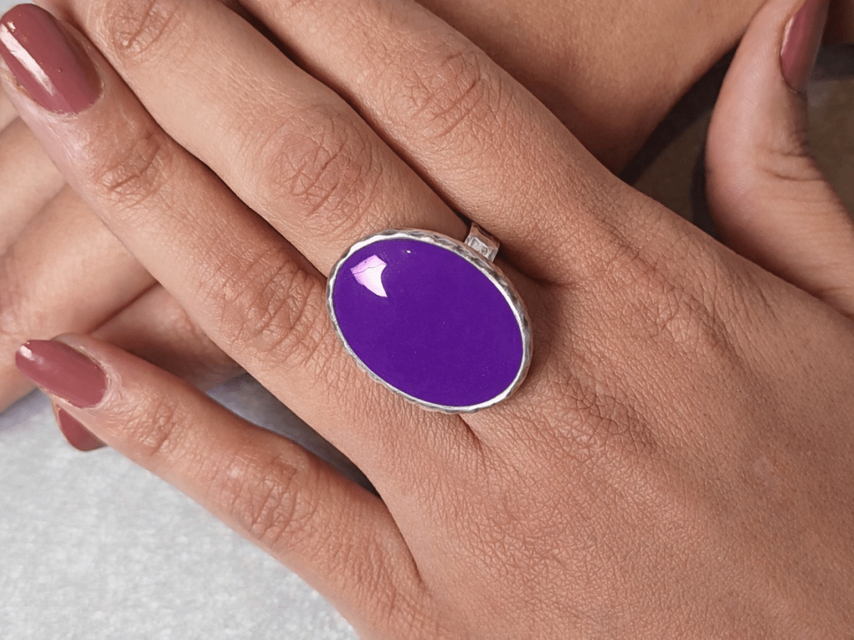 A models hands wearing a purple ring
