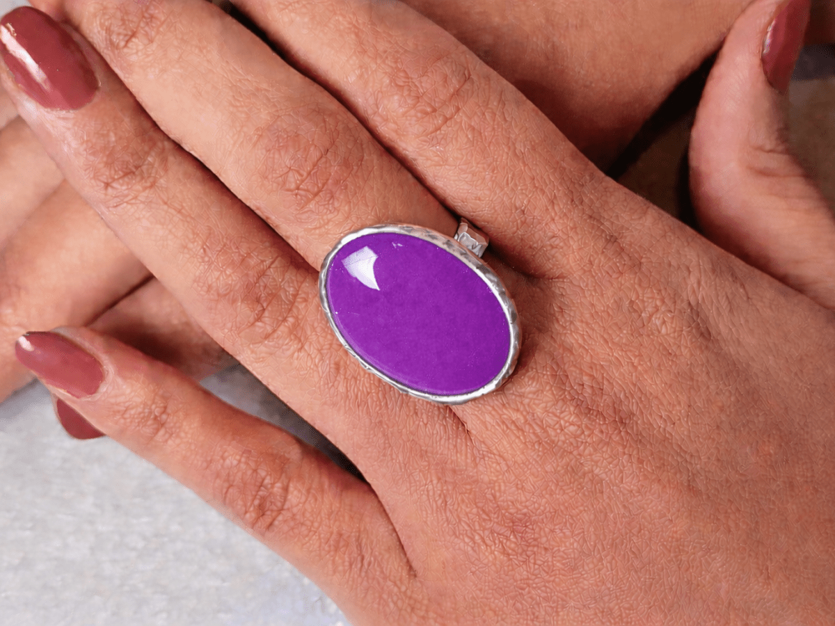 A models hands wearing a violet ring
