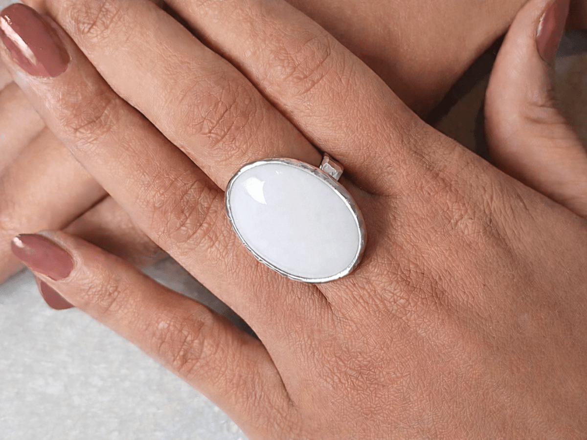 A models hands wearing a white ring