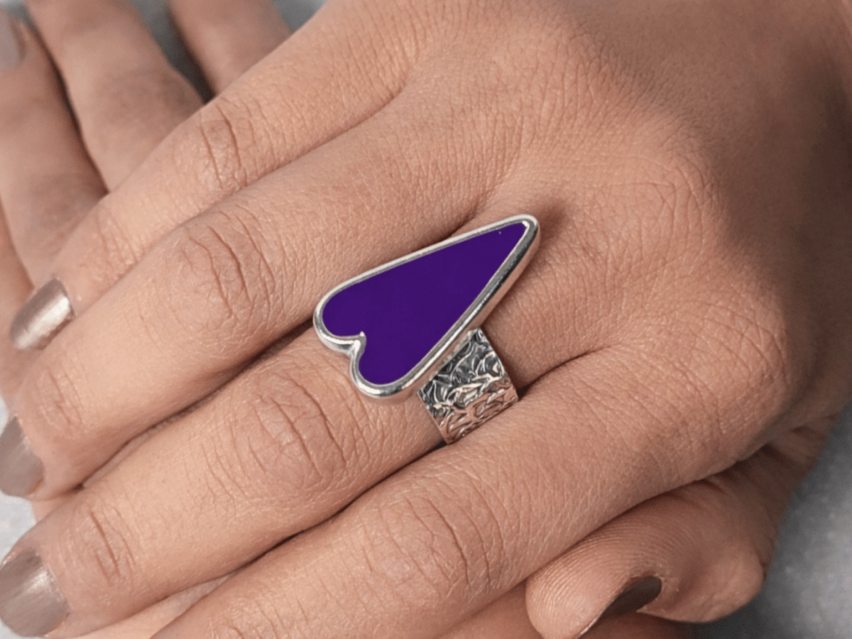 A models hands wearing a purple heart ring