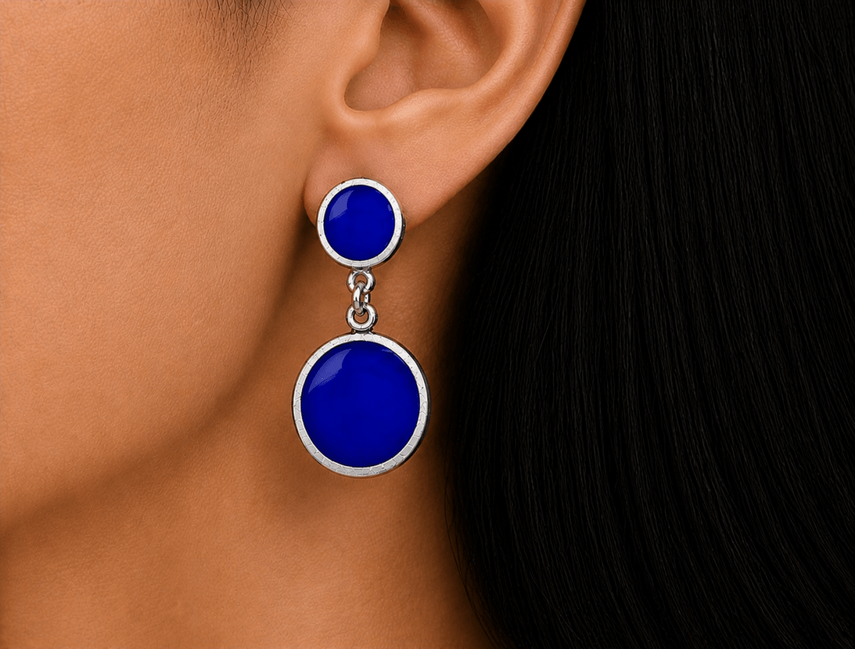 A model wearing some round royal blue dangle drop earrings