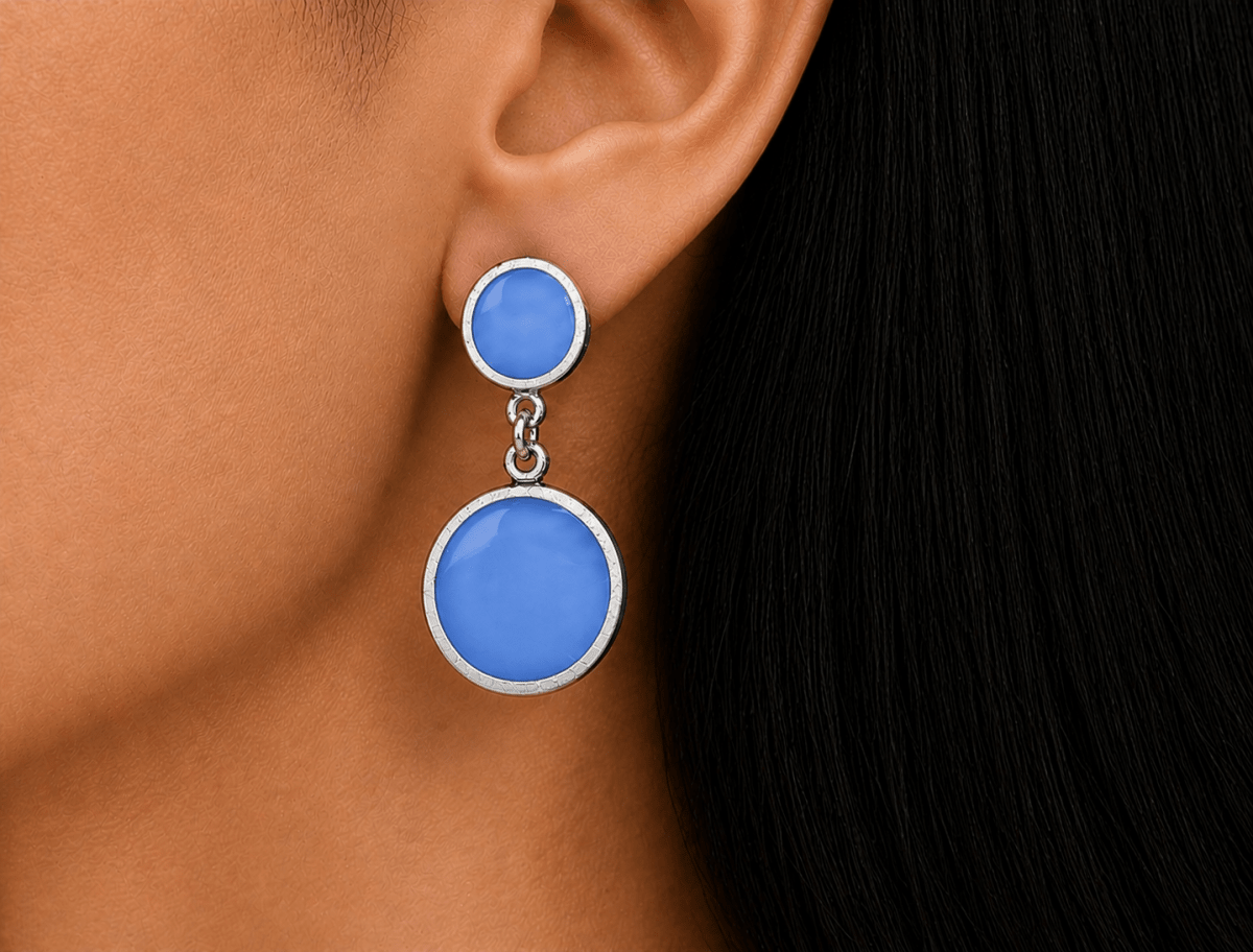 A model wearing some round blue dangle drop earrings