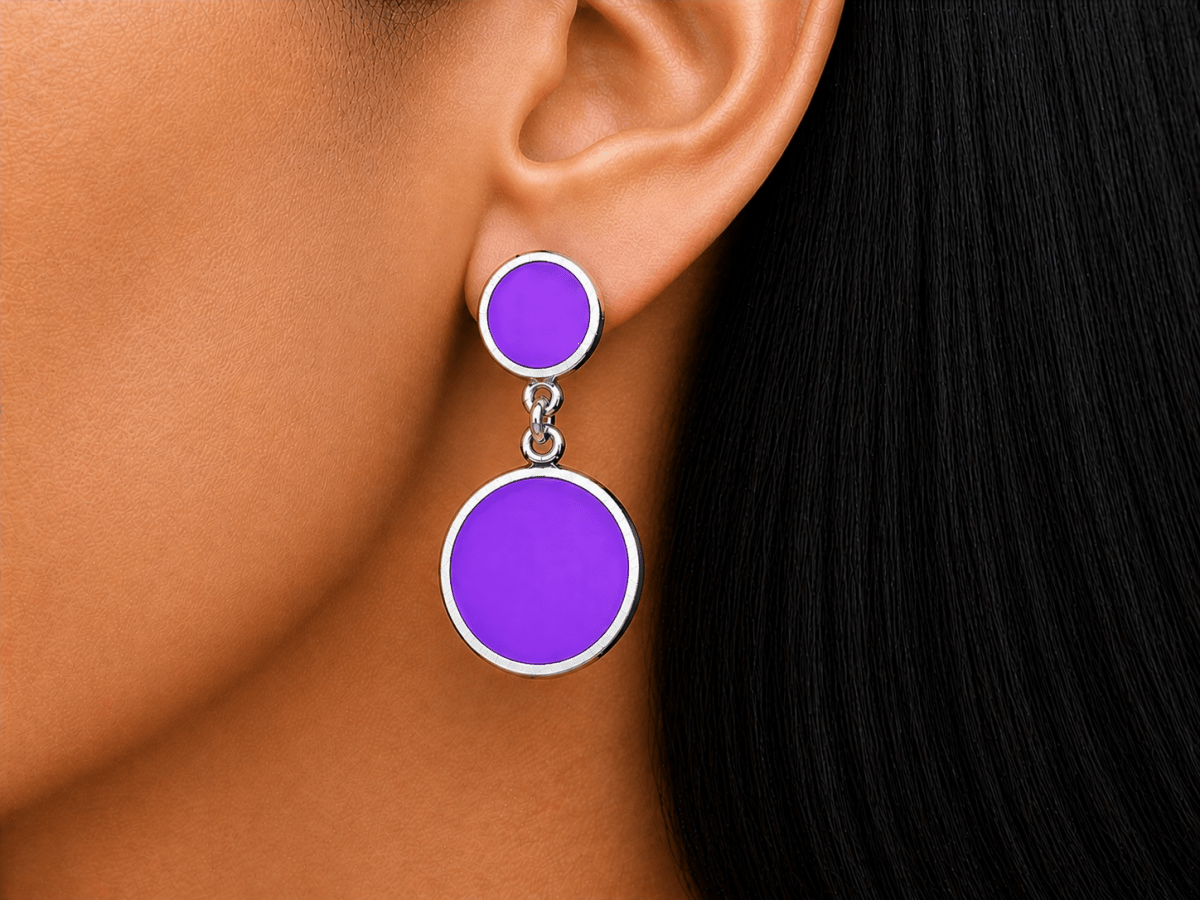 A model wearing some round violet dangle drop earrings