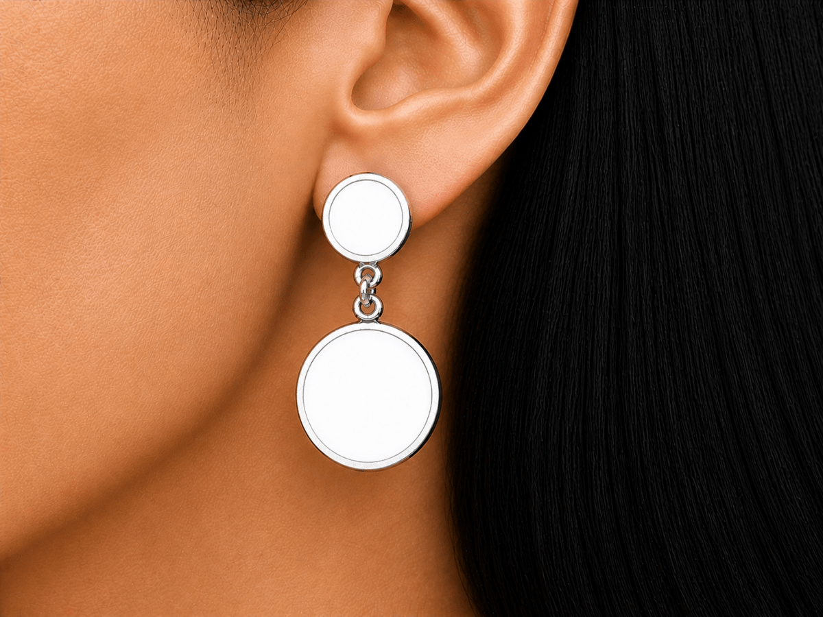 A model wearing some round white dangle drop earrings