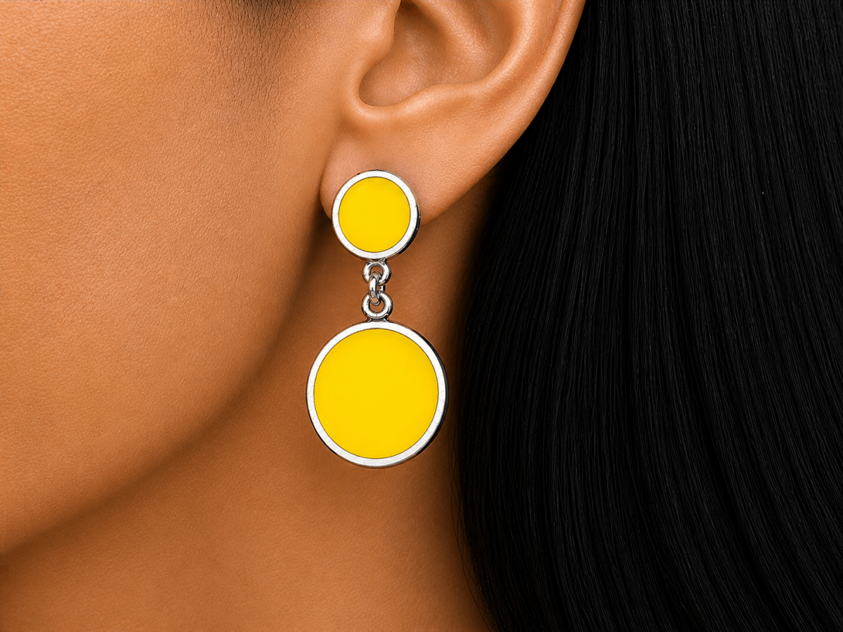A model wearing some round yellow dangle drop earrings