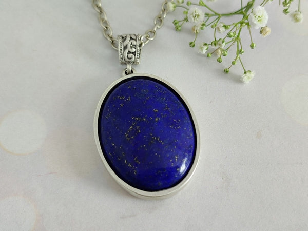 A Lapis Laziuli pendant on a grey surface