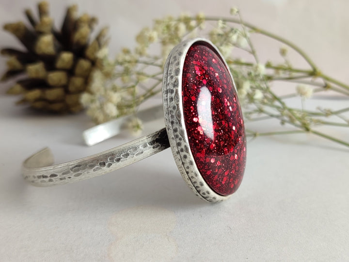 Narrow red bangle with a large red glittery cabochon, silver bangle, open bangle