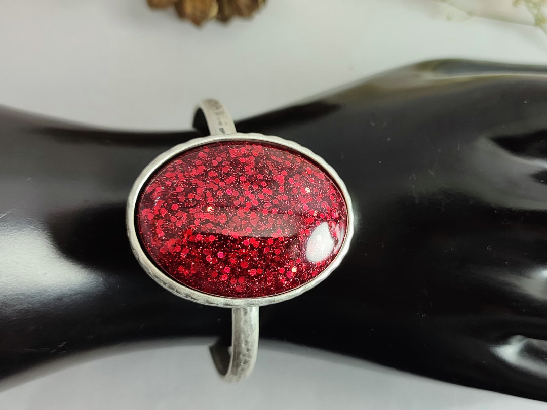 Narrow red bangle with a large red glittery cabochon, silver bangle, open bangle