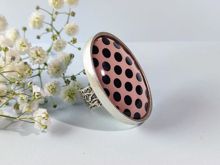 Pink and black spotted oval ring